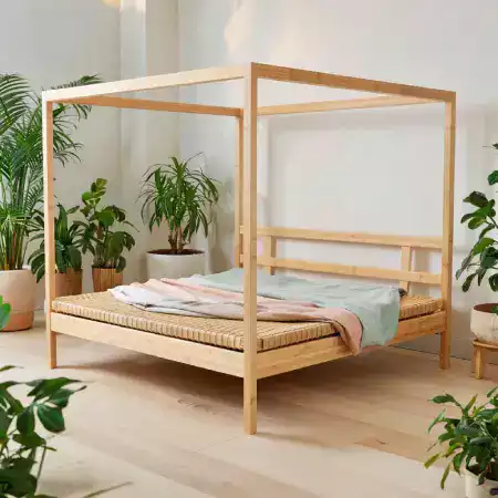 Handcrafted Bamboo Double Bed with Storage Features in Munnar Eco-Resort's Deluxe Room